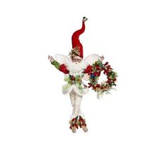 a christmas angel ornament hanging from the ceiling with holly wreaths and bells