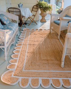 a room with wicker furniture and rugs on the floor