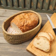 a loaf of bread sitting on top of a wooden cutting board next to a knife