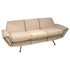 a cream colored couch with black metal legs on an isolated white background for use as a sofa