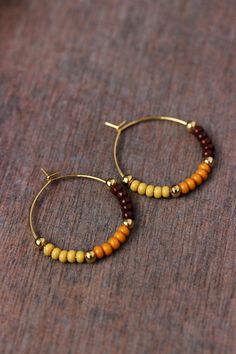 Unique boho earrings with glass seed beads (dark chocolate brown,mustard-yellow colors), small gold tone metal beads and gold tone stainless steel round hoop earrings. Earring hooks are from nickel free and lead free metal. Perfect jewelry for everyday wear or a great gift for someone special! Diameter of hoops is 25 mm Other earrings of my shop you can see here: https://www.etsy.com/shop/NaTavelli?section_id=13757927  Thanks for visit. Brown Beaded Hoop Earrings As Gift, Brown Beaded Hoop Earrings For Gift, Handmade Brown Small Hoop Earrings, Handmade Small Brown Hoop Earrings, Brown Beaded Hoop Earrings, Brown Beaded Bohemian Hoop Earrings, Brown Bohemian Beaded Hoop Earrings, Bohemian Brown Beaded Hoop Earrings, Earrings Seed Beads