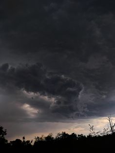 the sky is very dark and cloudy with some clouds