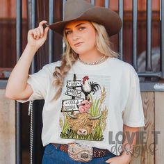 a woman wearing a cowboy hat and t - shirt