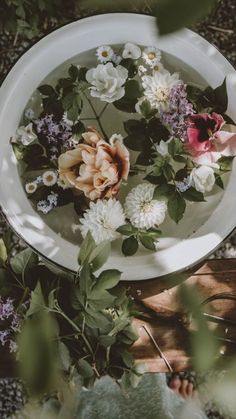 a white plate with flowers floating in it