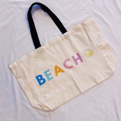 This Sunny Beach Canvas Tote is a great choice for anyone looking for a lightweight, large capacity bag. Made of canvas, it provides a stylish yet comfortable way to carry all your essentials. The beautiful color theme and happy face sun design will bring extra joy to your everyday tasks or beach trips. One side printing, spacious inside, no lining, no pockets Dimensions: approximately 19” x 16” x 6” Ethically sourced, reusable, recyclable, no plastic packaging Machine washable cold gentle cycle Face Sun, Sun Design, Jewelry Roll, Beach Canvas, Beach Trips, Packaging Machine, Sun Designs, Sunny Beach, Color Theme