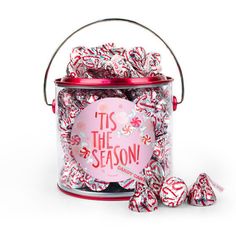 red and white candies in a tin with its saying it's the season