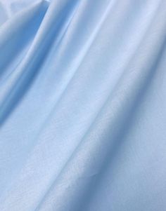 a close up view of a light blue fabric