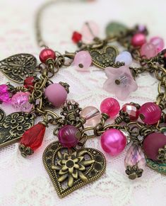 "- Vintage Style Valentines Charm Bracelet Bronze Chain is adjustable from 6.5\" - 8\" with an extension chain The bracelet links are filled with crystals, glass beads and pearls in shades of pink and red Mixed between the beads are vintage style heart charms - all are bronze, some have patina Search my store categories \"Necklaces\" and \"Earrings\" for matching pieces. This is a great gift for Mother's Day Your bracelet will be carefully gift packaged and shipped via USPS First Class Mail. Fee Metal Heart-shaped Beaded Bracelets For Valentine's Day, Heart-shaped Metal Beaded Bracelets For Valentine's Day, Metal Heart-shaped Beaded Bracelet For Valentine's Day, Pink Bohemian Bracelets For Valentine's Day, Bohemian Pink Bracelets For Valentine's Day, Pink Heart-shaped Beaded Charm Bracelet, Charming Pink Heart Jewelry, Charming Pink Heart-shaped Jewelry, Vintage Adjustable Heart Bracelet For Valentine's Day