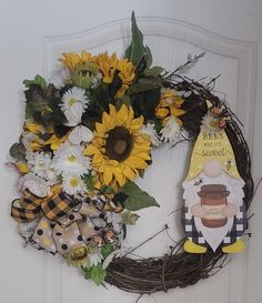 a wreath with sunflowers and other decorations on it