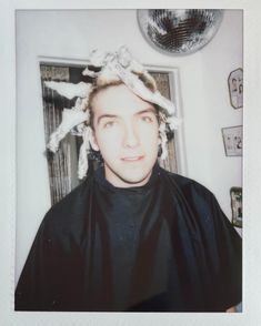 an old photo of a woman with her hair pulled back and wearing a black shirt