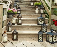 a set of steps with lanterns and flowers on it