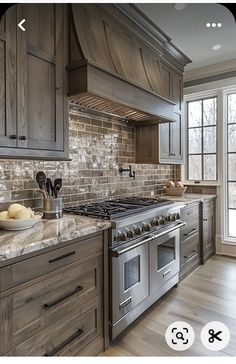 a kitchen with wooden cabinets and marble counter tops, along with stainless steel stove top ovens