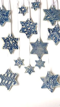 some blue and white ornaments hanging from strings