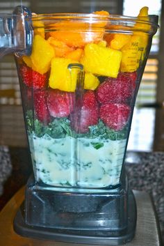 a blender filled with fresh fruit and yogurt