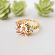 The topaz and minty crystals ring is a beautiful vintage-style piece of jewelry that makes a unique statement. This gold-plated ring features a stunning combination of colors that will surely catch the eye. The size 7 ring is perfect for women who love to add a dash of elegance to their outfit. Whether you're dressing up for a special occasion or just want to add a bit of flair to your everyday look this crystal statement ring is the perfect choice for any fashion-forward woman. - Material & Col Gold Topaz Crystal Ring With Accent Stones, Gold Topaz Ring With Gemstone Accents, Gold Topaz Ring With Accent Stones For Promise, Gold Topaz Promise Ring With Accent Stones, Gold Rings With Topaz Gemstone Accents, Wedding Topaz Ring With Gemstone Accents, Gold Crystal Ring With Gemstone Accents For Wedding, Gold Topaz Wedding Ring With Gemstone Accents, Gold Topaz Wedding Ring