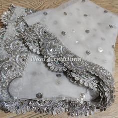 Silver sequin motifs on net. Indian dupatta. Net dupatta with scallop border. Custom made dupattas More dupatta here in our collection https://www.etsy.com/shop/neelcreations/?section_id=15880219 This Dupatta is embroidered on net with beautiful Scallop silver border. This can be your wedding dress chunni. Border has beautiful work of faux pearls, mirrors and kundan. ★ It can be made in other colors. ★We can increase the length if required. Approximate length 90-95 inches. We can increase length Dupatta Designs Ideas, Lace Designs On Suits, Plazo Designs, Indian Dupatta, Dupatta Style, Simple Lehenga, Scallop Border, Embroidered Scarf, Punjabi Suit