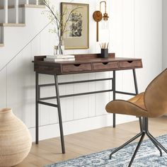 a desk with two drawers and a chair next to it in front of a staircase