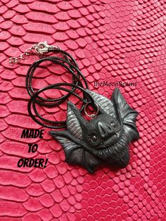 "MADE TO ORDER PROCESSING TIME 2-3 WEEKS It will be created for you, just like the one in the pictures, please allow slight variations due to the handmade nature of the piece, which makes each bat unique :) The new version of my classic Chubby Bat pendant Made by me using Black polymer clay,with silver accents(wings and ears) With Hematite eyes. It is 2\" wide and 2\" tall the back is flat It comes with a black cotton cord 18\" with a 2\" extension chain It comes in a gift box CARE: Please keep Hand Painted Black Resin Jewelry, Spooky Black Necklace For Gift, Handmade Black Vampire Necklace, Hand Painted Black Polymer Clay Jewelry, Unique Black Halloween Necklace, Handmade Black Necklace For Cosplay, Handmade Black Jewelry For Cosplay, Handmade Polymer Clay Halloween Jewelry, Handmade Resin Jewelry For Halloween