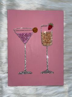 two wine glasses with strawberries on them are made out of glitter and pink paper