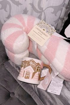 a pink and white striped stuffed animal with a mug