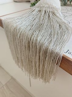 white beaded purse sitting on top of a table