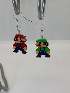 the earrings are made out of legos and have an image of mario on them