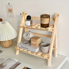 a wooden shelf with books, candles and other items