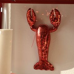 there is a red lobster sculpture on the wall