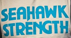 a towel with the words seahawk strength printed on it, in blue and white