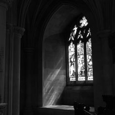 sunlight shining through the stained glass windows in a church