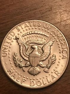 the united states of america silver dollar on a wooden table with stars and an eagle