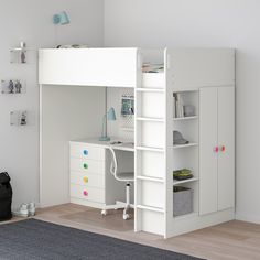 a white loft bed with desk underneath it