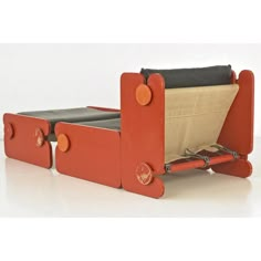 an orange and black toy bed with wheels