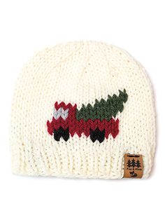 a white knitted hat with red, green and black designs on it's brim