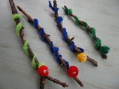 four different types of twigs are arranged in the shape of caterpillars with eyes on them