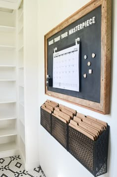 a blackboard with writing on it is mounted to the wall next to a white bookcase