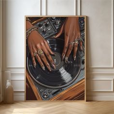 a woman's hands on top of a record player in front of a wall