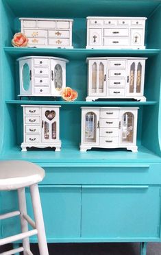 there is a blue shelf with white drawers on it