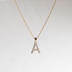 Diamond initials pendant necklace comes with adjustable 16"-18" gold chain. Metal: 14k Yellow Gold Stone: Natural Diamonds Stone Size: 1.4mm Diamond Color and Clarity: G+, VS Pendant Size: approx 10mm x 9mm varies by letter. Diamond Weight: 0.23 total carat weight for letter A Chain: 1.1mm, Adjustable 16" to 18" rolo chain Letter A - Z