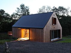 a small wooden house sitting on top of a gravel field