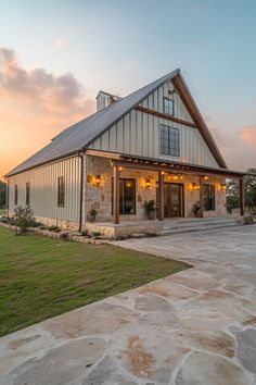 a house with a large front porch and covered patio area in the middle of it