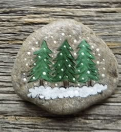 a painted rock with trees on it