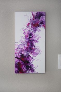 a painting is hanging on the wall next to a light switch