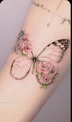 a butterfly with pink roses on its wings is shown in this tattoo design by artist, amanda