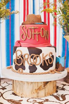 a three tiered cake is decorated with brown, pink and blue frosting that says suffo brooks