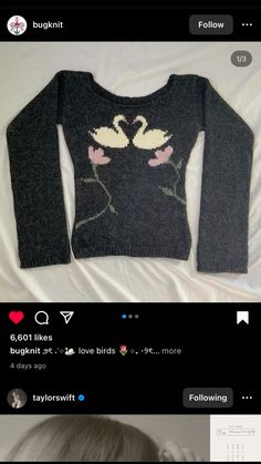 a sweater with two swans on it and the words love birds in pink are shown