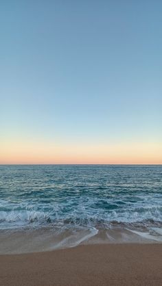 the ocean waves are rolling in to shore