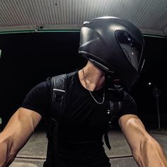 a man wearing a black shirt and helmet