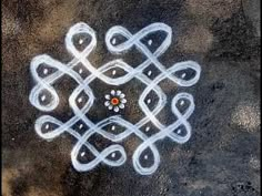 an intricate design on the ground with white lines and red center surrounded by black dots