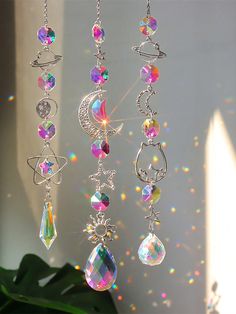 the sun shines brightly in the background as it hangs from a chain with crystal beads